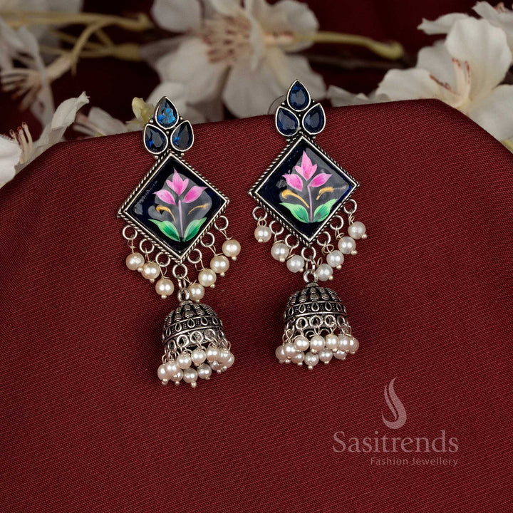 Oxidised blue Monalisa diamond-cut jhumka earrings styled to elevate fashionable festive looks with stunning detail – Sasitrends