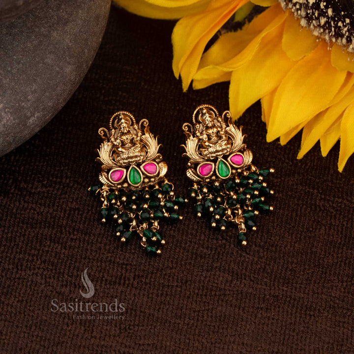 Royal Matte Gold Lakshmi Temple Earrings featuring exquisite ruby-green stones and glowing pearl accents, exuding divine temple artistry and timeless heritage elegance – Sasitrends