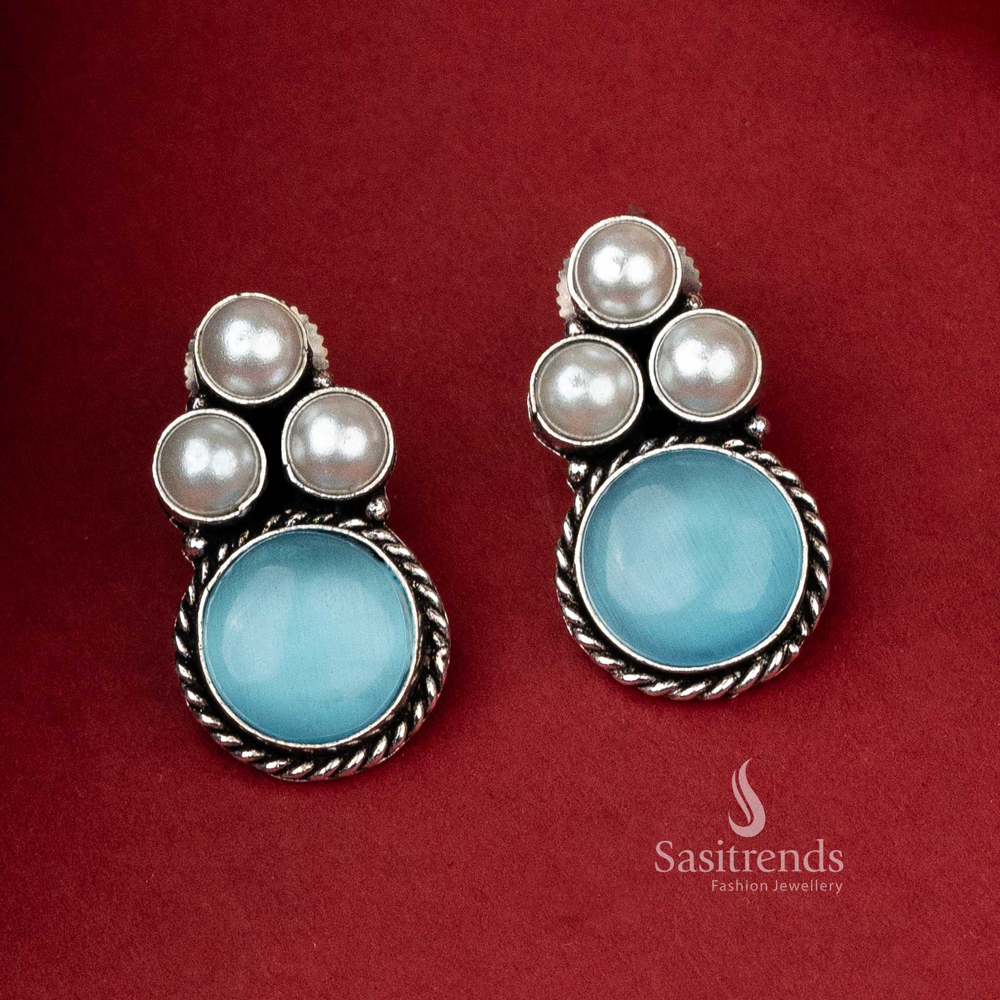 Unique oxidized silver earrings with a serene blue monalisa stone set beneath a cluster of gleaming pearls