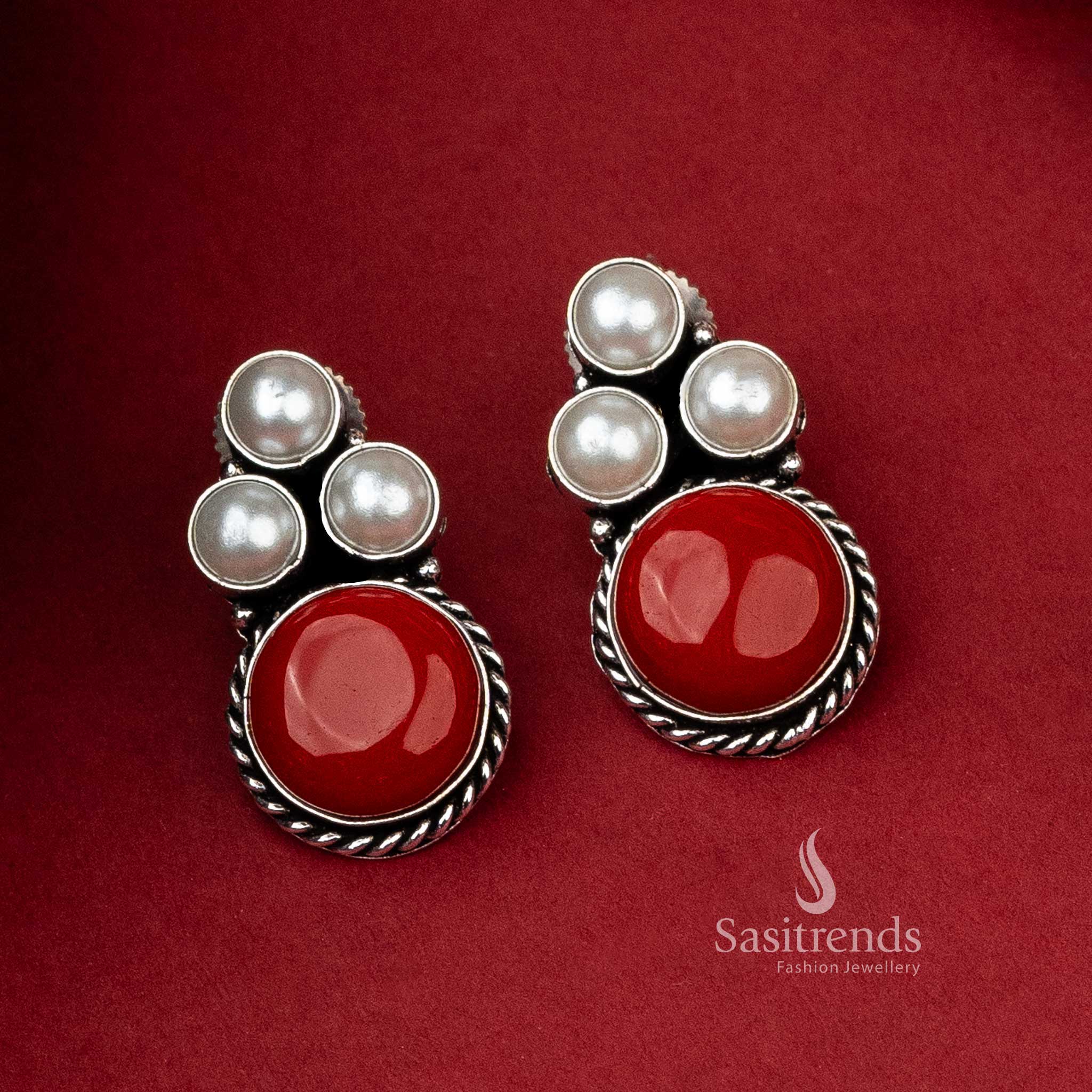 Oxidised silver earrings featuring a subtle silver monalisa stone and a trio of pearls for a refined aesthetic