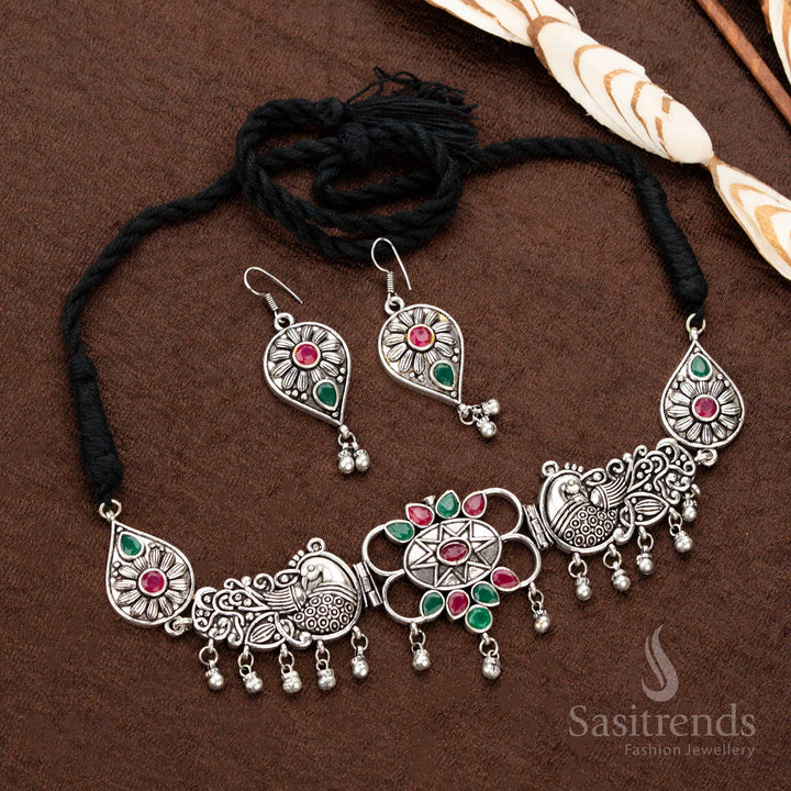 Beautiful oxidised Navaratri necklace set, featuring a combination of ruby and green stones, elegant peacock engravings, ornate floral work, and teardrop accents, making it a must-have traditional jewellery piece - Sasitrends