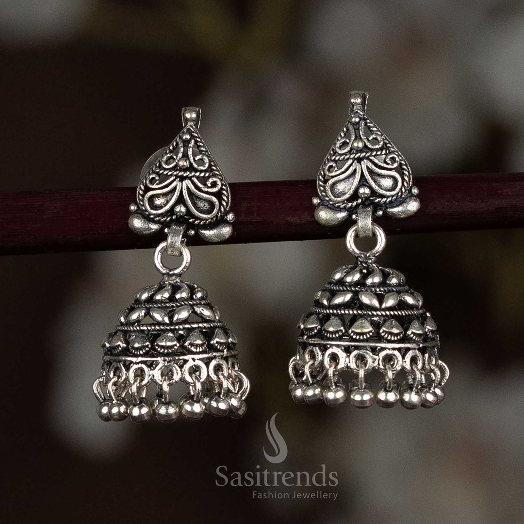 Elegant oxidised silver jhumka earrings with a bold floral stud top and antique dome engraving, ideal for both everyday ethnic looks and festive occasions – Sasitrends