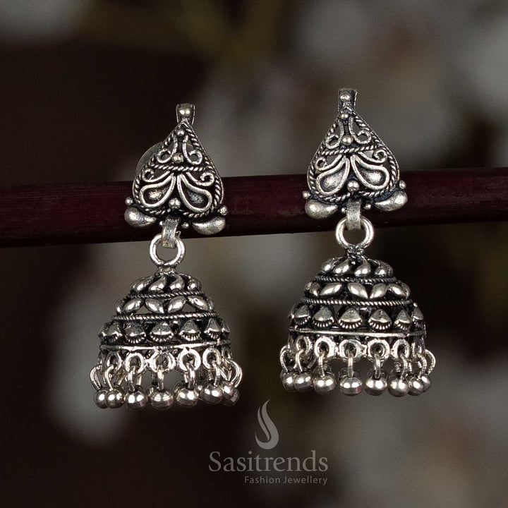 Elegant oxidised silver jhumka earrings with a bold floral stud top and antique dome engraving, ideal for both everyday ethnic looks and festive occasions – Sasitrends