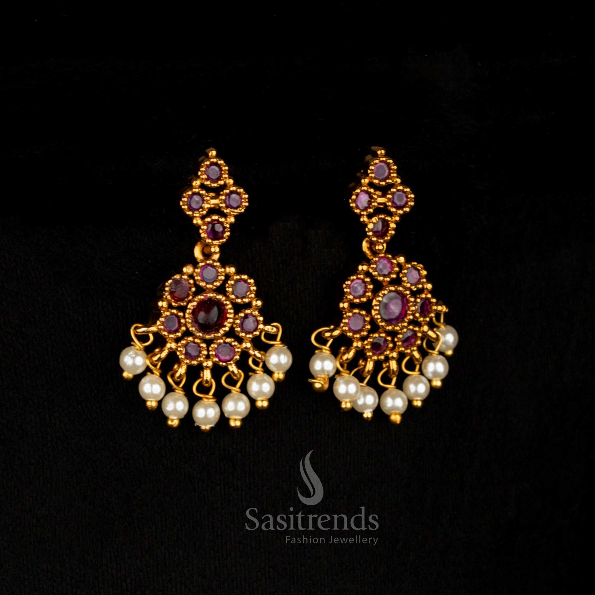 Fiery glow matte gold AD stone earrings with bold ruby circular floral motifs and delicate drop styling, creating an eye-catching temple bridal lustre – Sasitrends