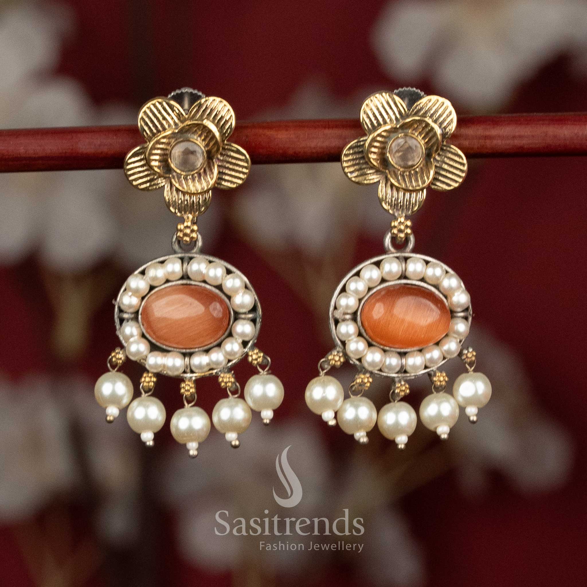 Vibrant oxidised silver floral stud earrings with bright orange Monalisa stones, artistic floral motifs and pearl accents for lively party styling - Sasitrends