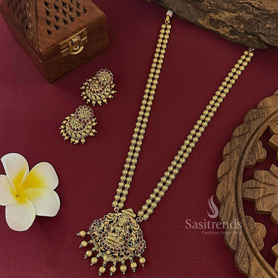 Regal ruby temple matte gold finish bridal long jewellery set with classic jhumkas and a floral motif pendant, designed for a graceful bridal appearance – Sasitrends
