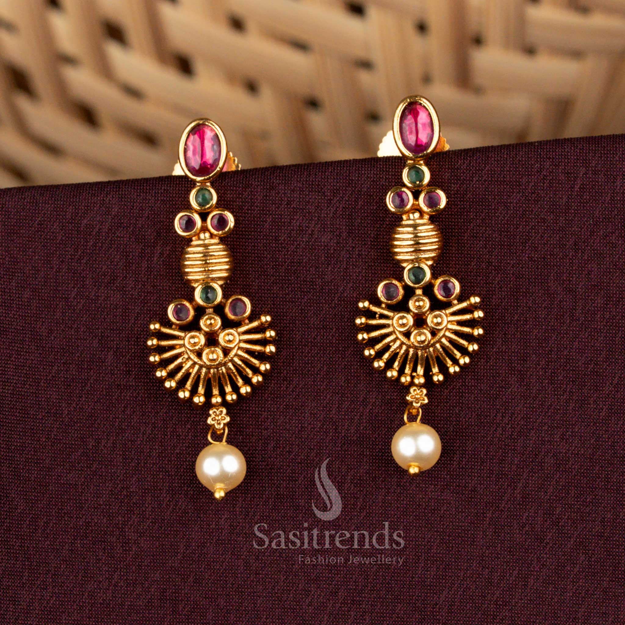Seraphic ruby green temple earrings styled with opulent matte gold artistry, majestic sunburst carvings, illustrious AD embellishments, and splendid pearl drops for bridal grandeur – Sasitrends