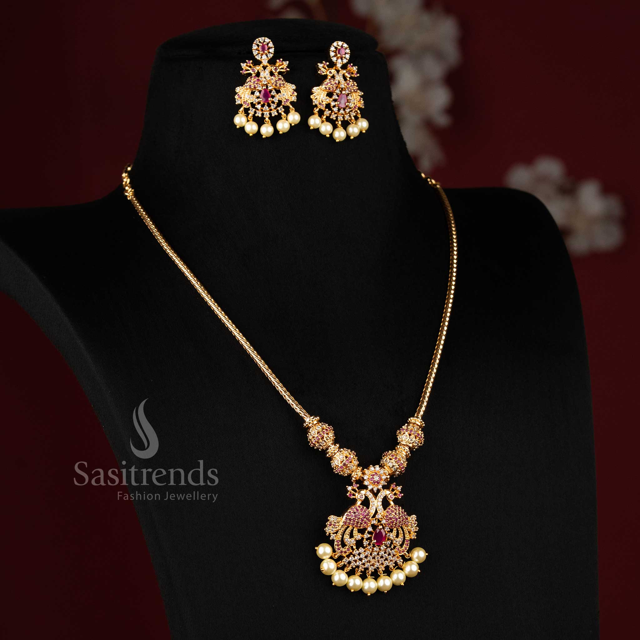 Elegant white ruby micro gold plated peacock AD pendant necklace jewellery set designed for festive gatherings, traditional attire and silk saree elegance - Sasitrends