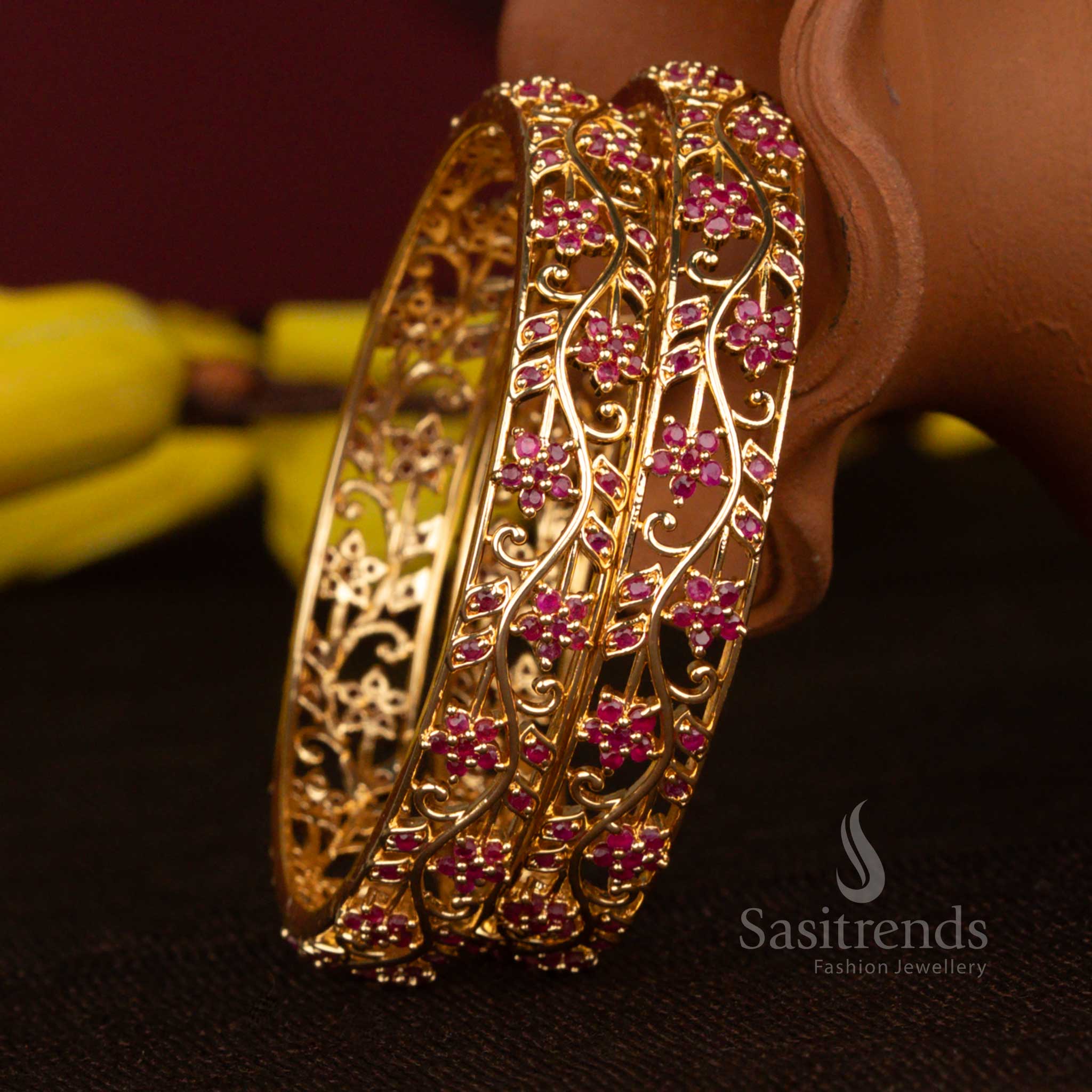 Regal micro gold plated floral leaf American diamond bangles with ruby accents ideal for celebrations and grand traditional wear – Sasitrends