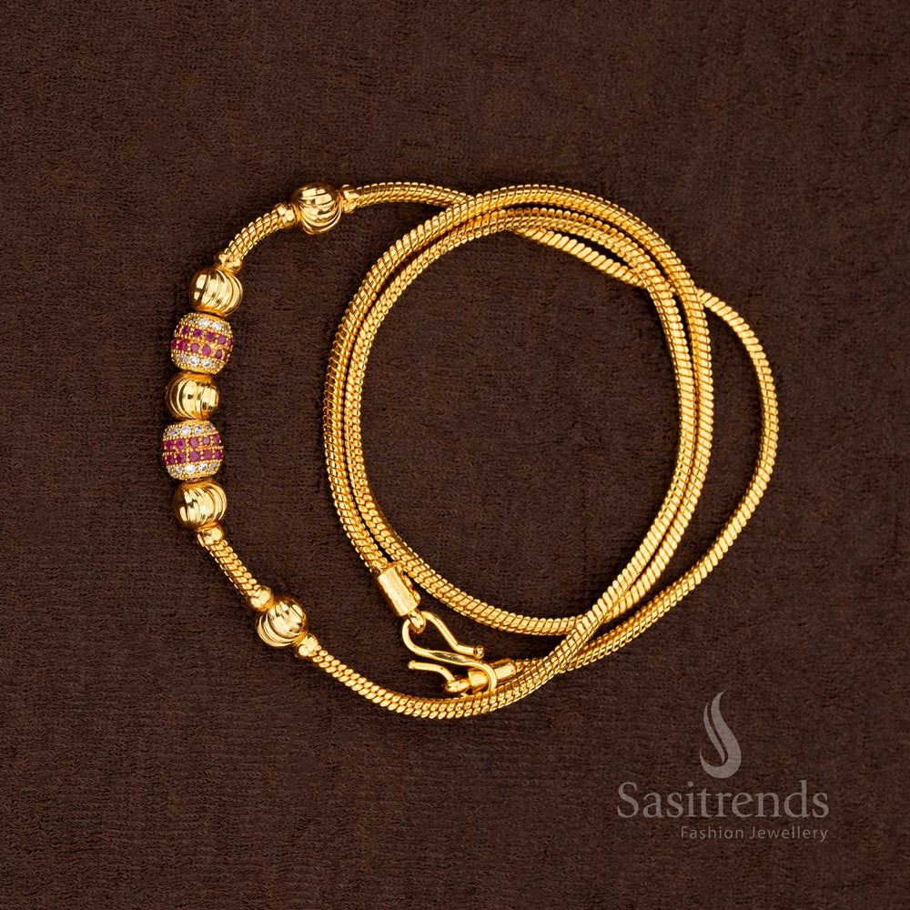 Rich ruby and white stones set in a micro gold plated chain with golden ball accents for festive elegance – Sasitrends