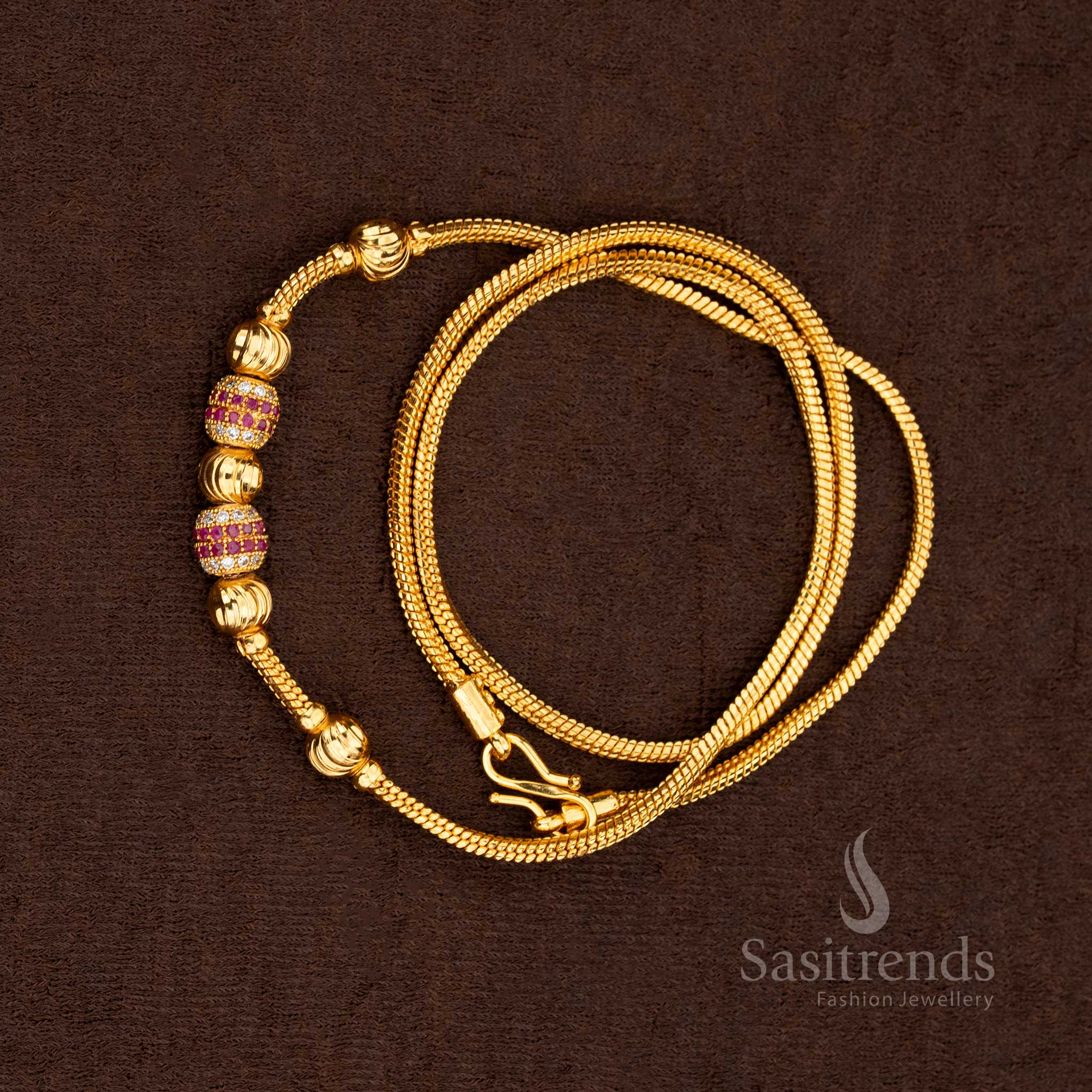 Rich ruby and white stones set in a micro gold plated chain with golden ball accents for festive elegance – Sasitrends