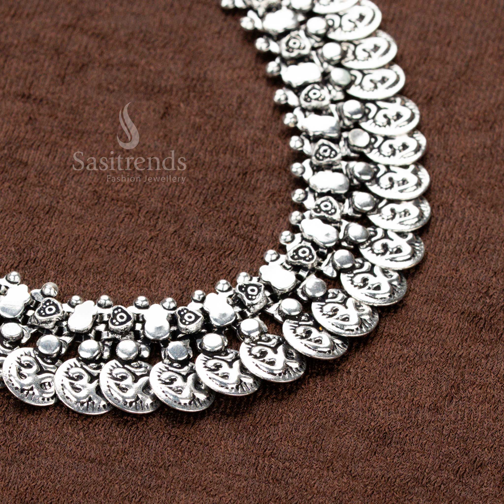 oxidised German silver choker necklace featuring intricately carved coin motifs and delicate floral accents, an exquisite piece for Navaratri styling, sarees, and ethnic grandeur - Sasitrends