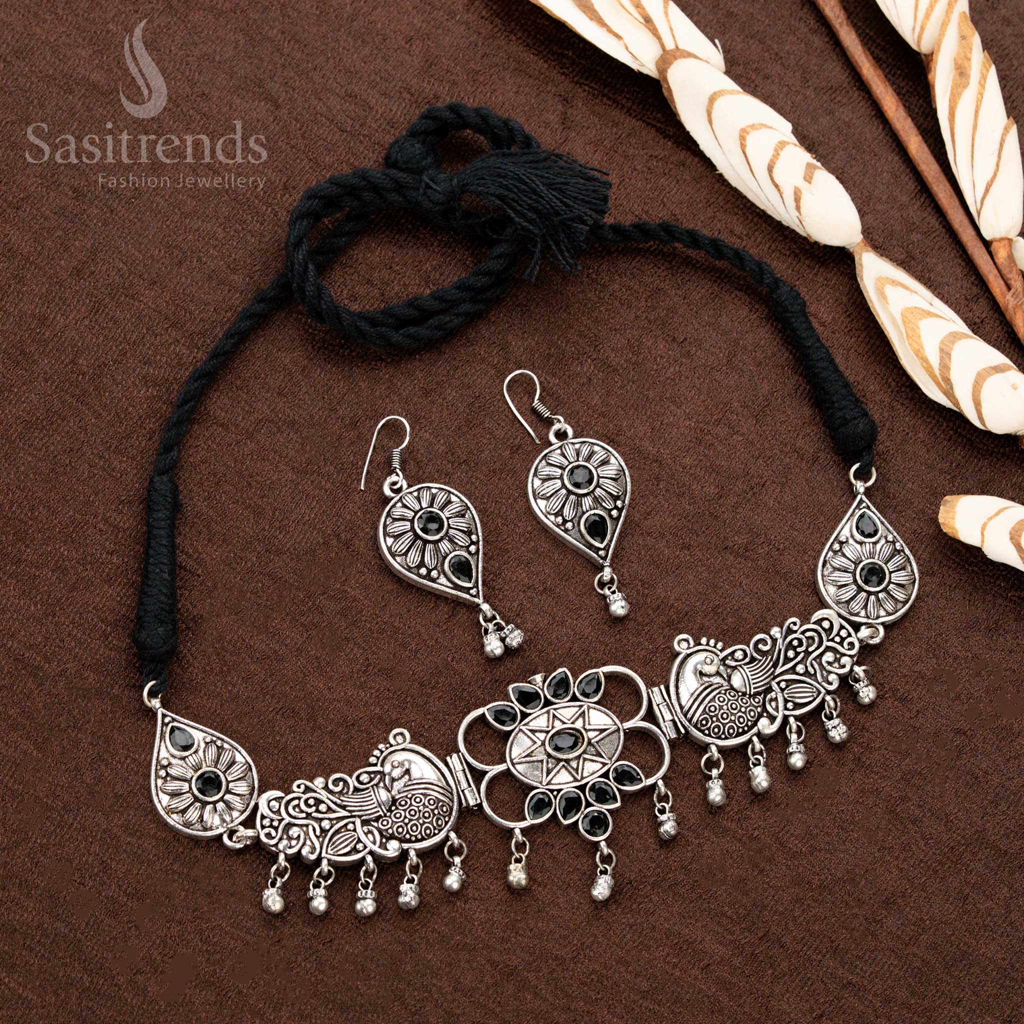 Stunning oxidised Navaratri necklace, adorned with black stones, a graceful peacock motif, central floral engravings, and classic teardrop elements, designed for timeless traditional jewellery - Sasitrends