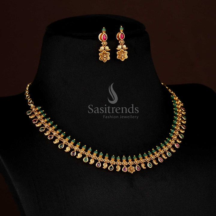 Splendid ruby-green temple inspired matte gold plated paisley necklace with floral carvings and AD teardrop charm, ideal for ethnic ceremonies – Sasitrends