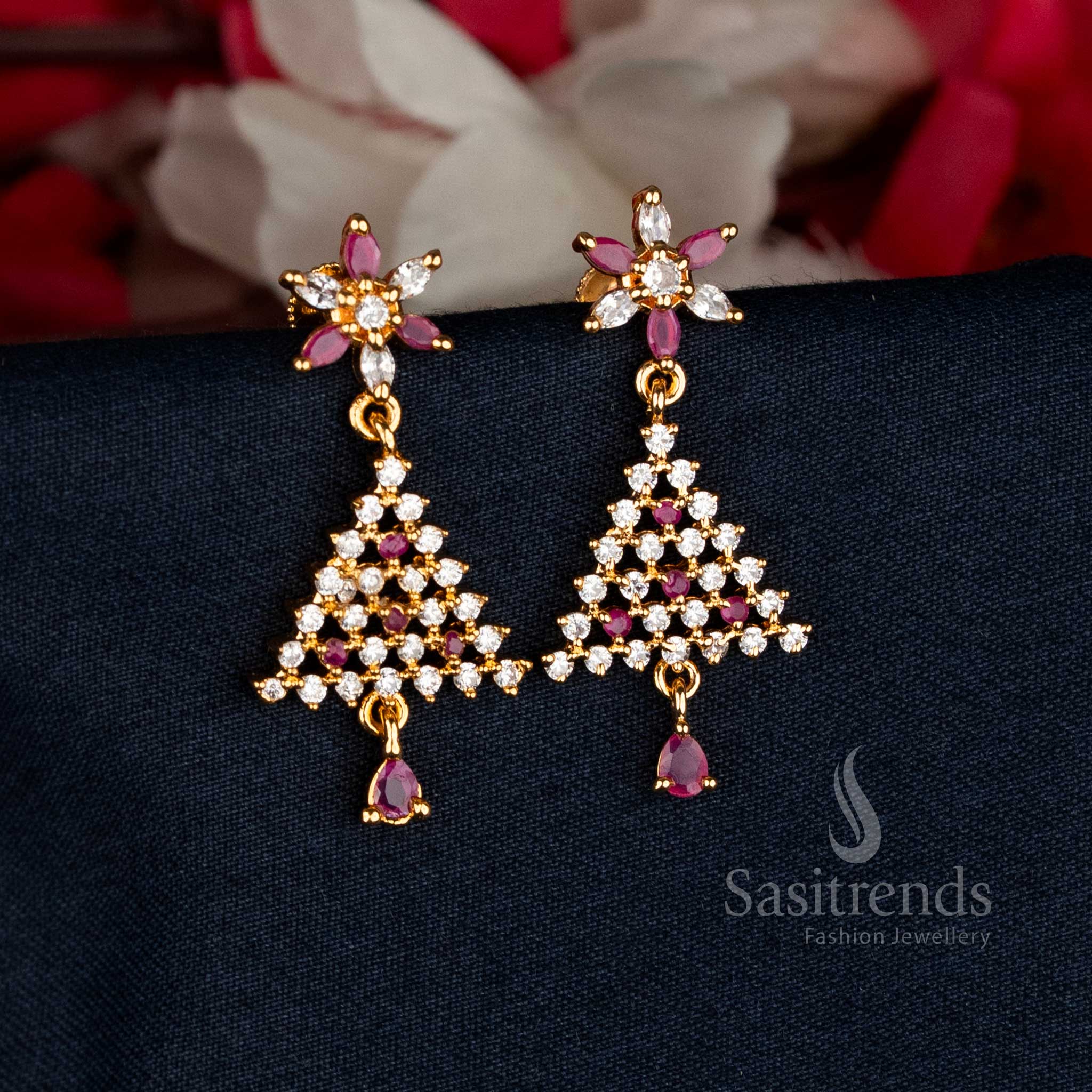 Regal White-Ruby Micro Gold Plated AD Stone Floral Triangular Stud Earrings showcasing intricate detailing and vibrant dual-tone sparkle, perfect for weddings, temple visits, and cultural celebrations — Sasitrends