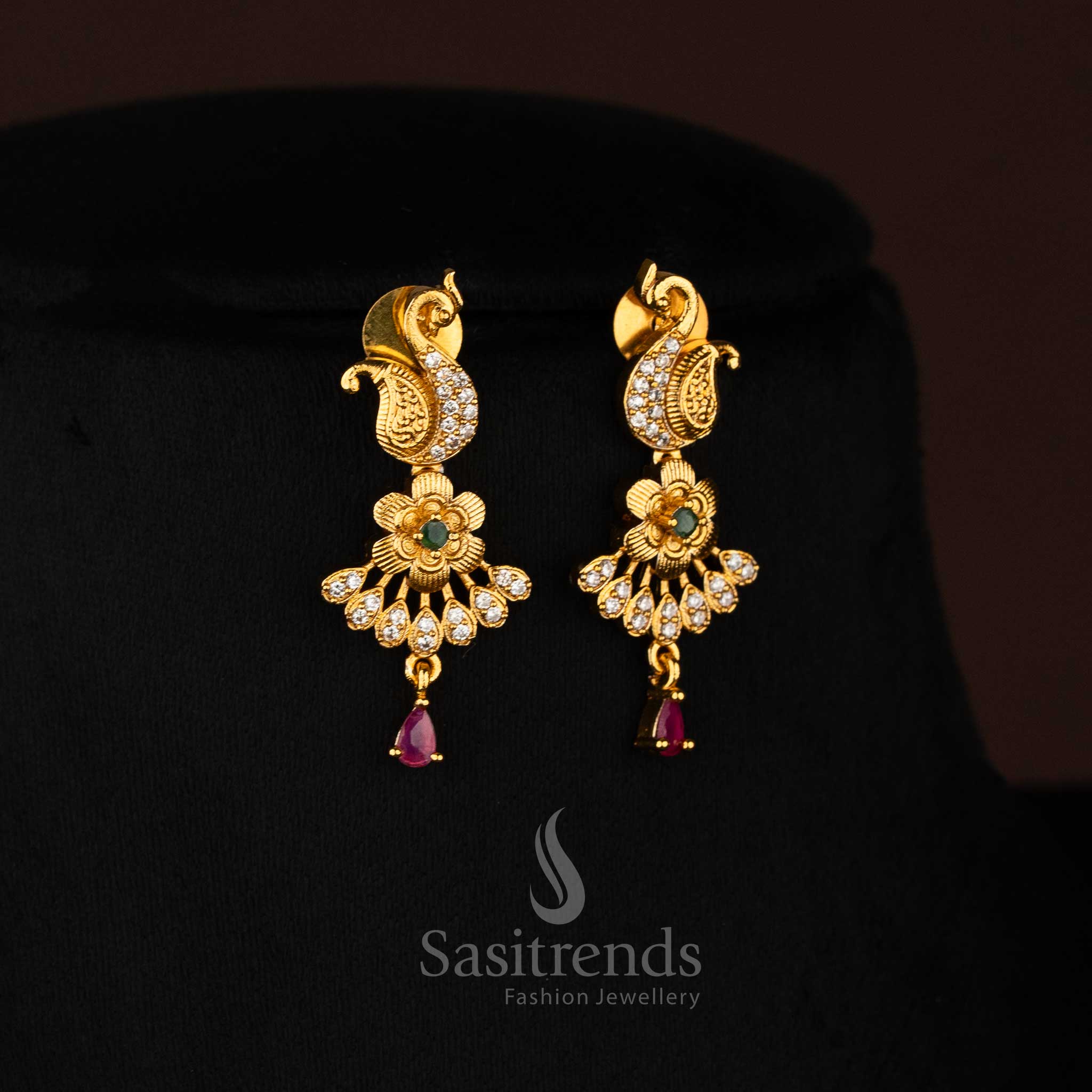 Heritage-style matte gold plated earrings featuring a refined peacock silhouette with intricate floral work and shimmering Multi kemp stone highlights, crafted for elegant festive and saree styling – Sasitrends