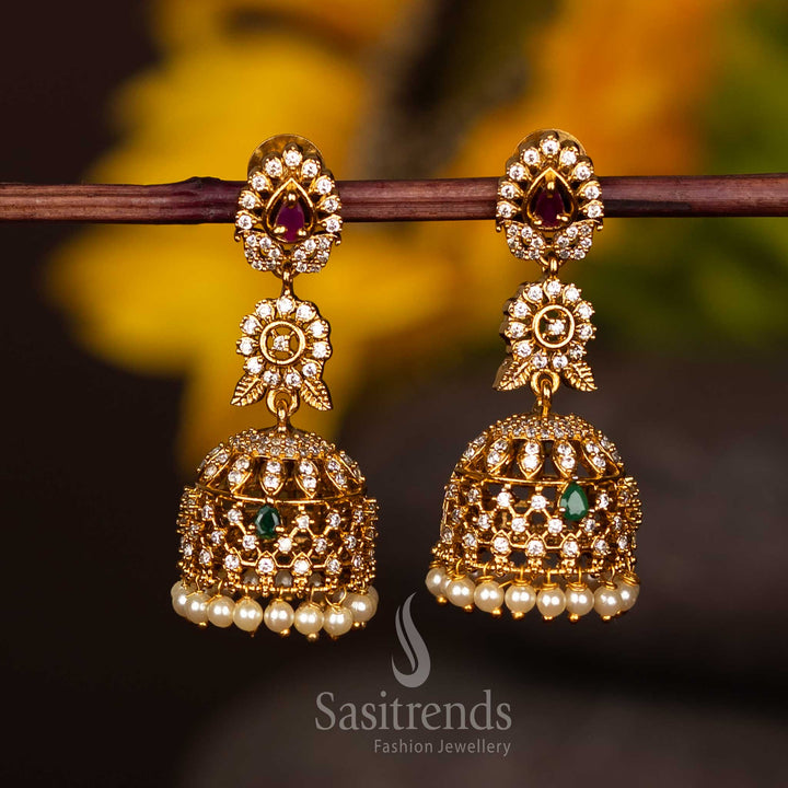 Beautiful Floral Leaf Matte Gold Jhumka Earrings With Antique Finish, Oval Gem Center, And Pearl Strands – A Statement Jewellery Accessory For Festive Occasions – Sasitrends
