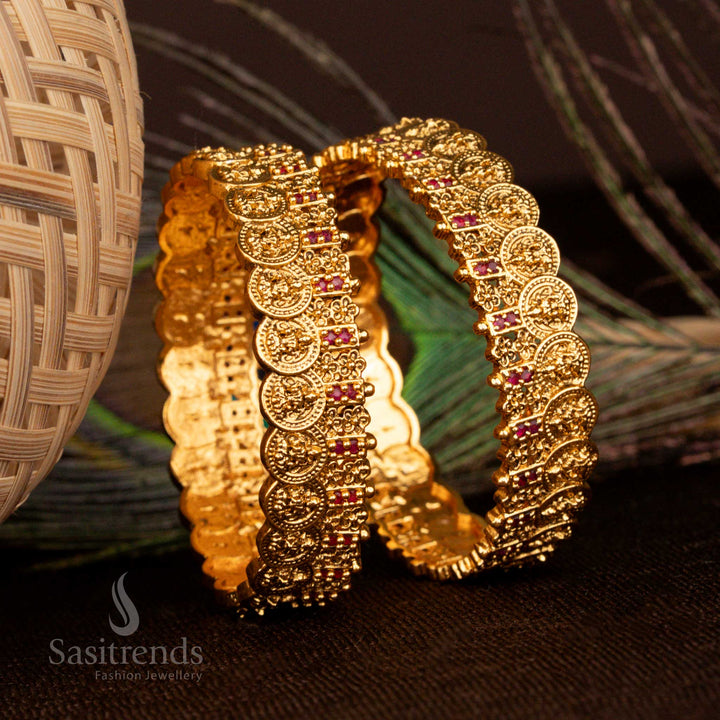Aristocratic temple matte gold Lakshmi coin floral bangles enriched with garnet ruby glow stones for a timeless wedding look - Sasitrends