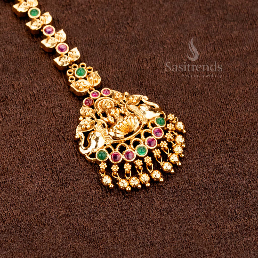Heritage inspired matte gold Lakshmi and peacock mango design tikka featuring elegant AD stone detailing and classic ethnic jewellery charm -sasitrends