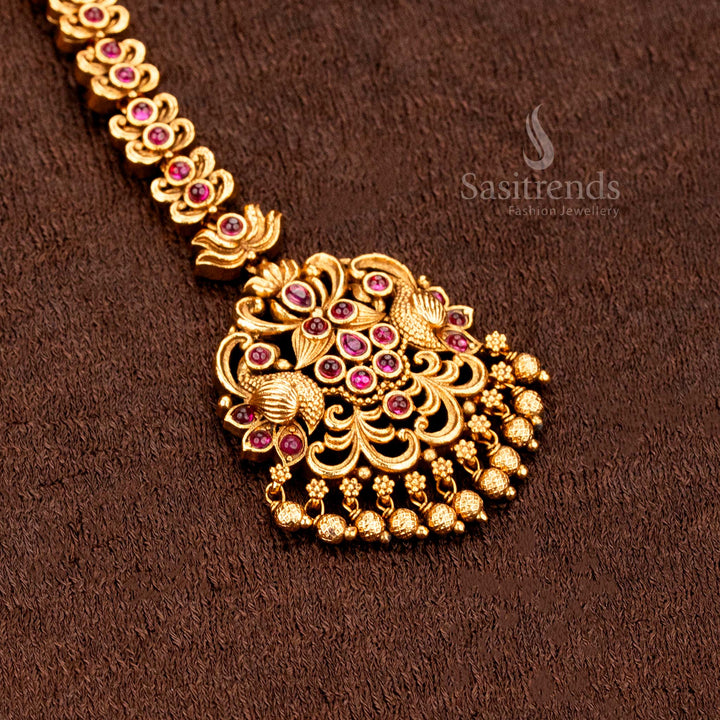 Majestic temple matte finish Lakshmi floral tikka decorated with delicate hanging balls and sparkling AD stones, perfect for brides' ethnic jewellery statements -sasitrends