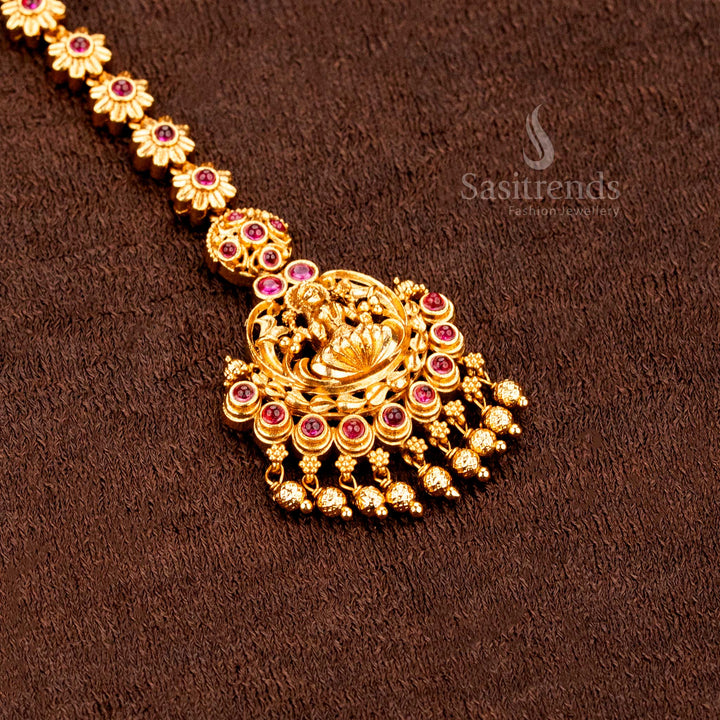 Elegant ethnic matte gold Lakshmi peacock tikka featuring shimmering AD stones and stunning traditional wedding jewellery glam - sasitrends