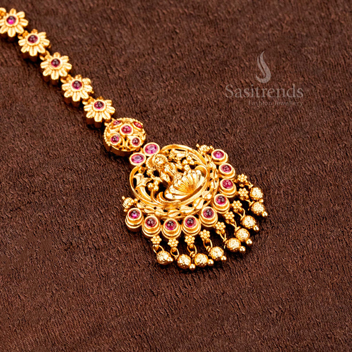 Graceful temple design matte gold floral Lakshmi tikka with shining AD stones, created for bridal beauty and traditional jewellery elegance -sasitrends