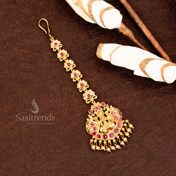 Ornate matte gold Lakshmi peacock mango floral tikka with fine AD embellishments, adding pure wedding jewellery charm and traditional spirit -sasitrends