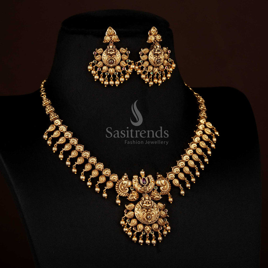 Regal ruby-green temple matte gold plated floral peacock Lakshmi necklace featuring hanging golden balls, ideal to wear for traditional festive occasions – Sasitrends