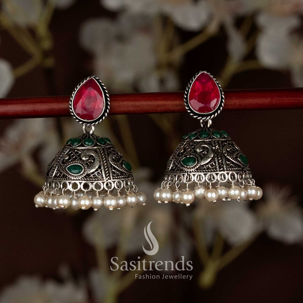 Ruby-green oxidised teardrop stud peacock motif jhumka earrings with pearl drops, designed for ethnic Navaratri saree wear, radiating graceful charm and vibrant festive beauty by Sasitrends