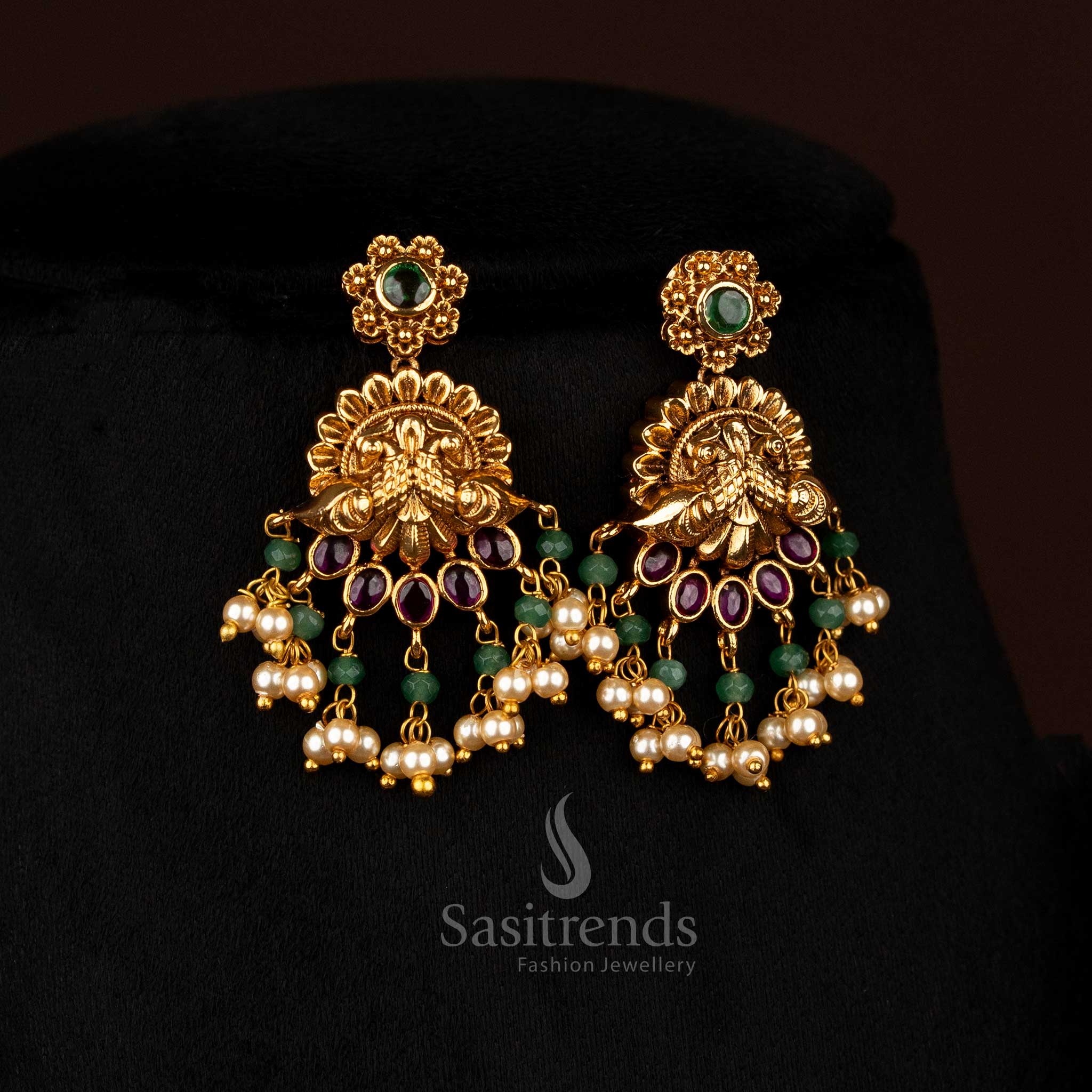 Luminous ruby-green matte gold plated floral dual peacock earrings adorned with pearl charms, designed to wear for festive occasions and temple gatherings – Sasitrends