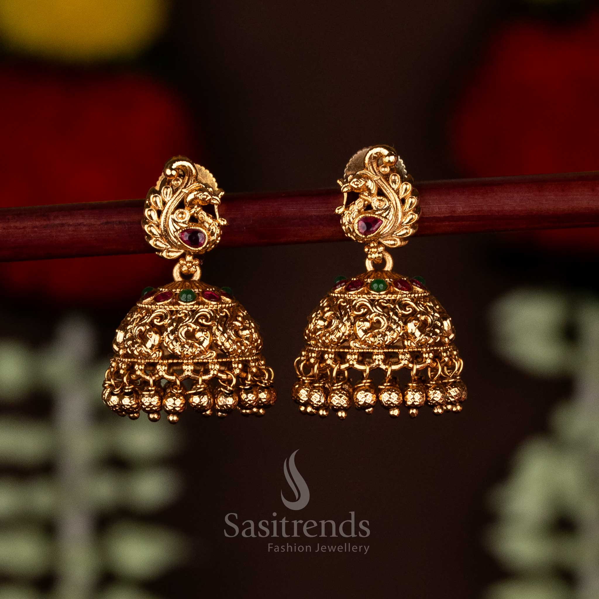Stunning ruby-green matte gold plated peacock temple small jhumka earrings, perfect for cultural celebrations and ethnic festive styling by Sasitrends