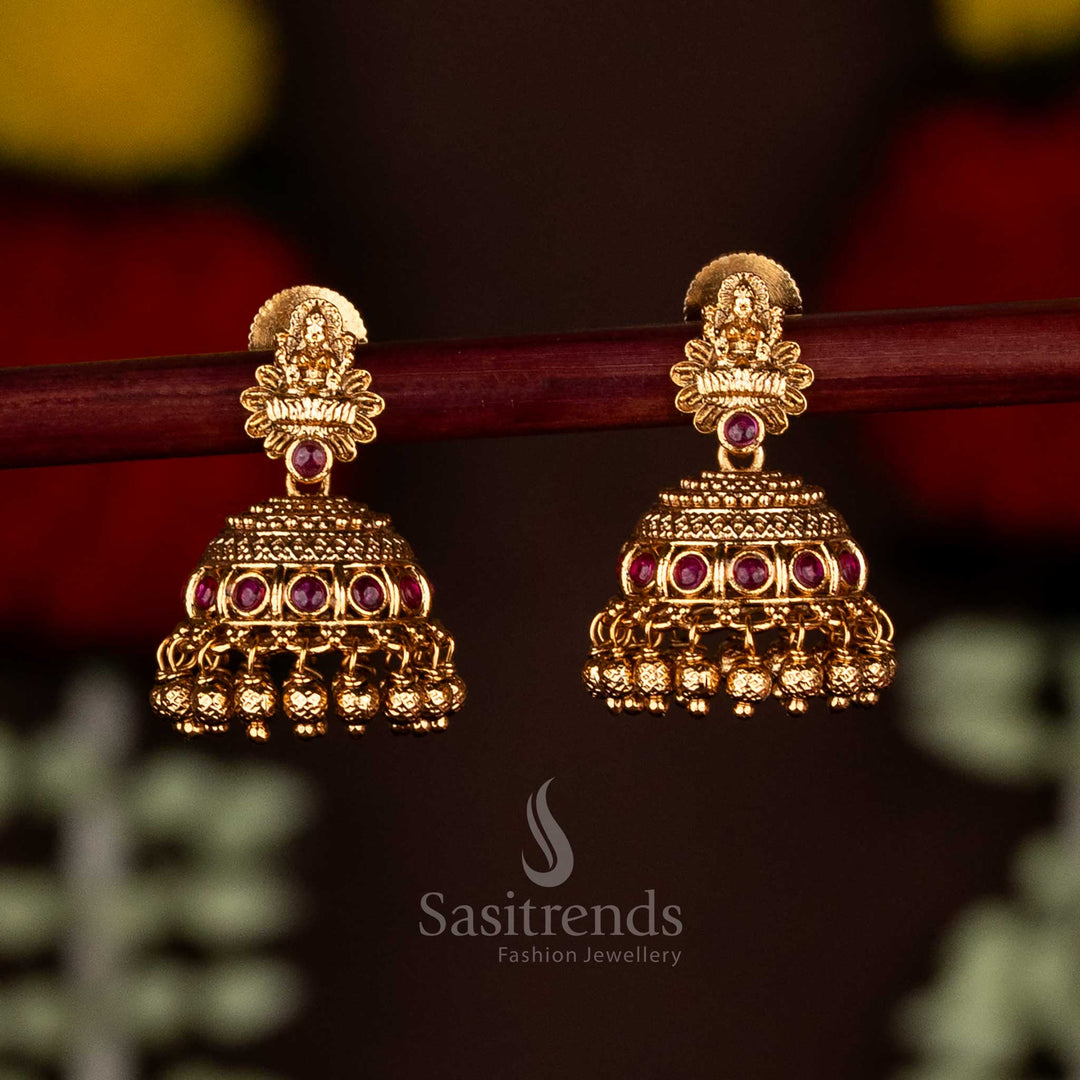 Graceful ruby matte gold plated Lakshmi floral jhumka earrings with ghungroo drops, a stunning choice for ethnic celebrations and cultural gatherings by Sasitrends