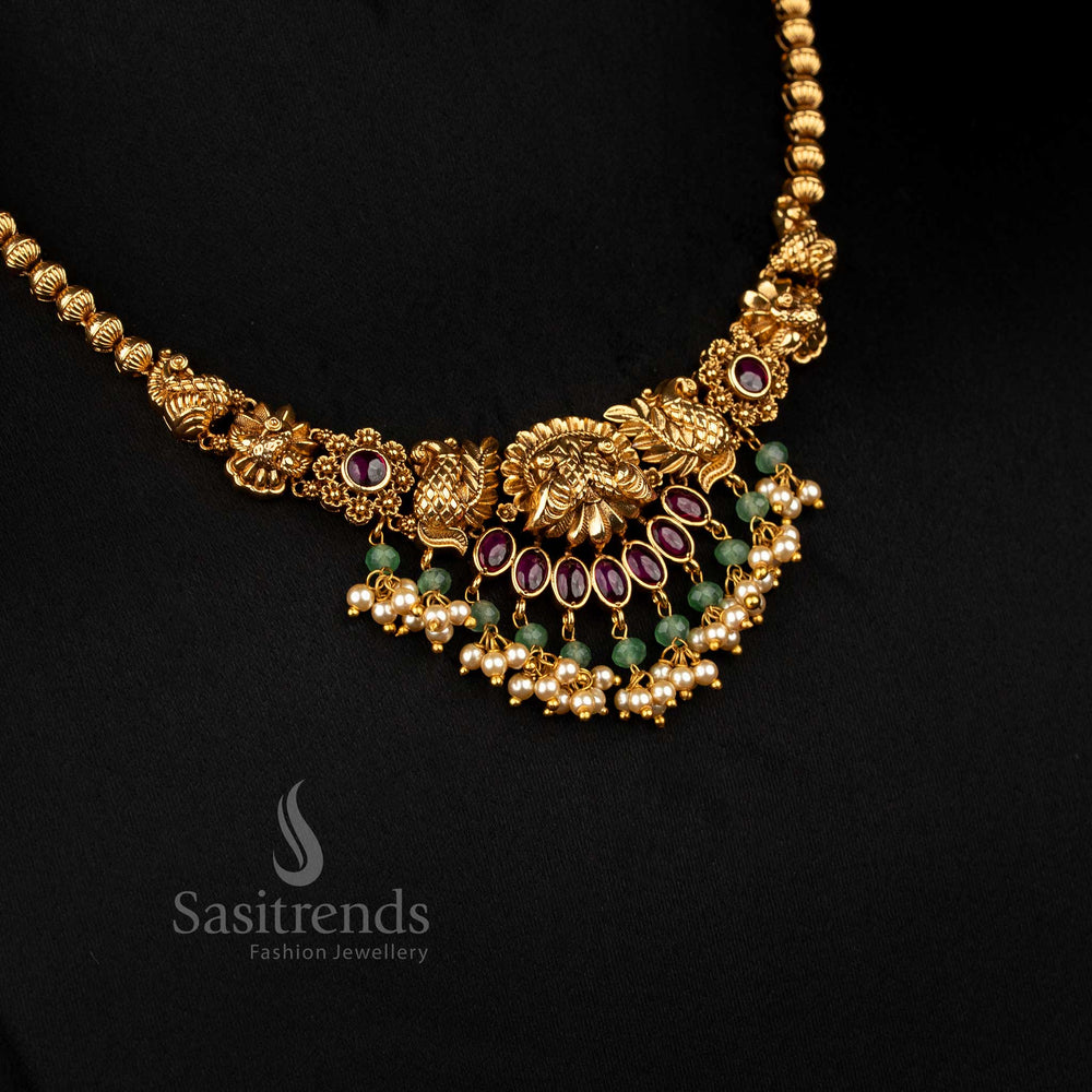 Opulent ruby matte gold plated floral dual peacock necklace with pearl danglings, designed to wear for temple ceremonies and festive traditional occasions – Sasitrends