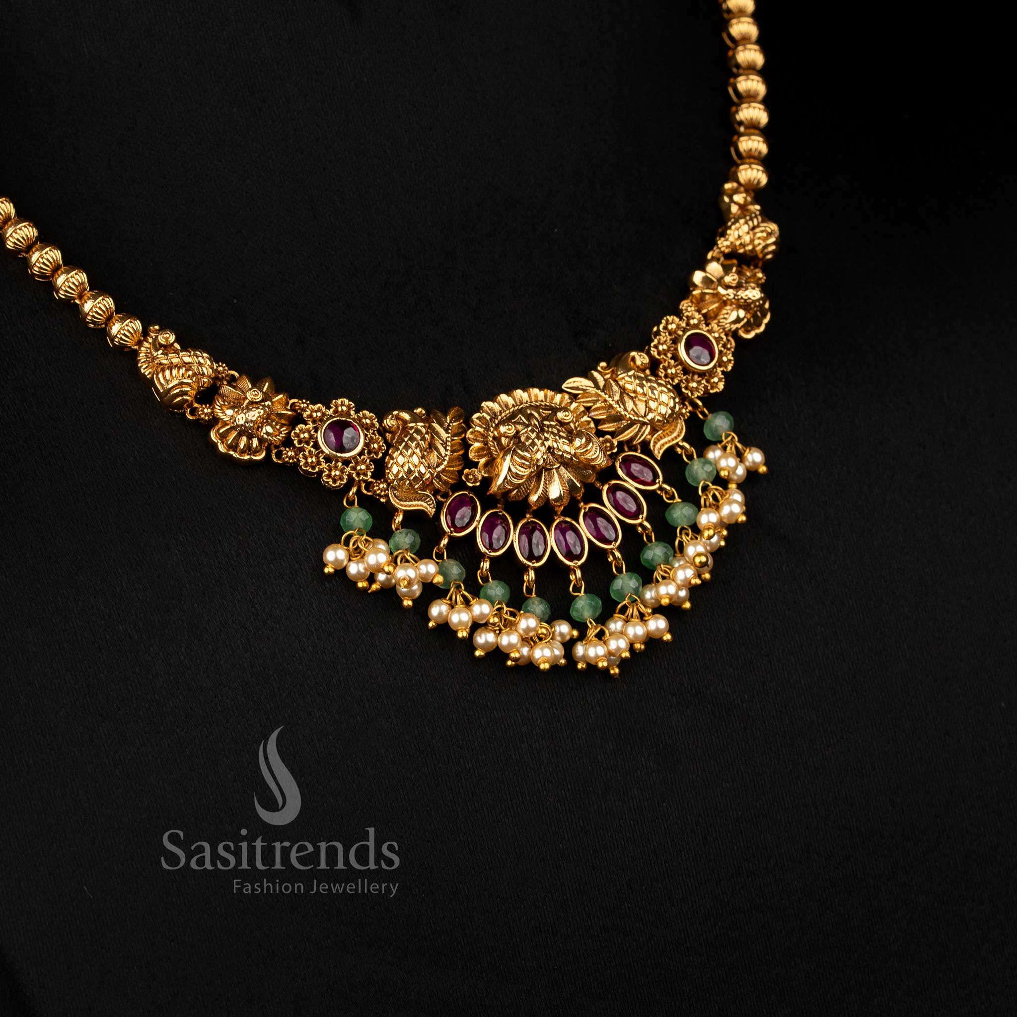 Opulent ruby matte gold plated floral dual peacock necklace with pearl danglings, designed to wear for temple ceremonies and festive traditional occasions – Sasitrends