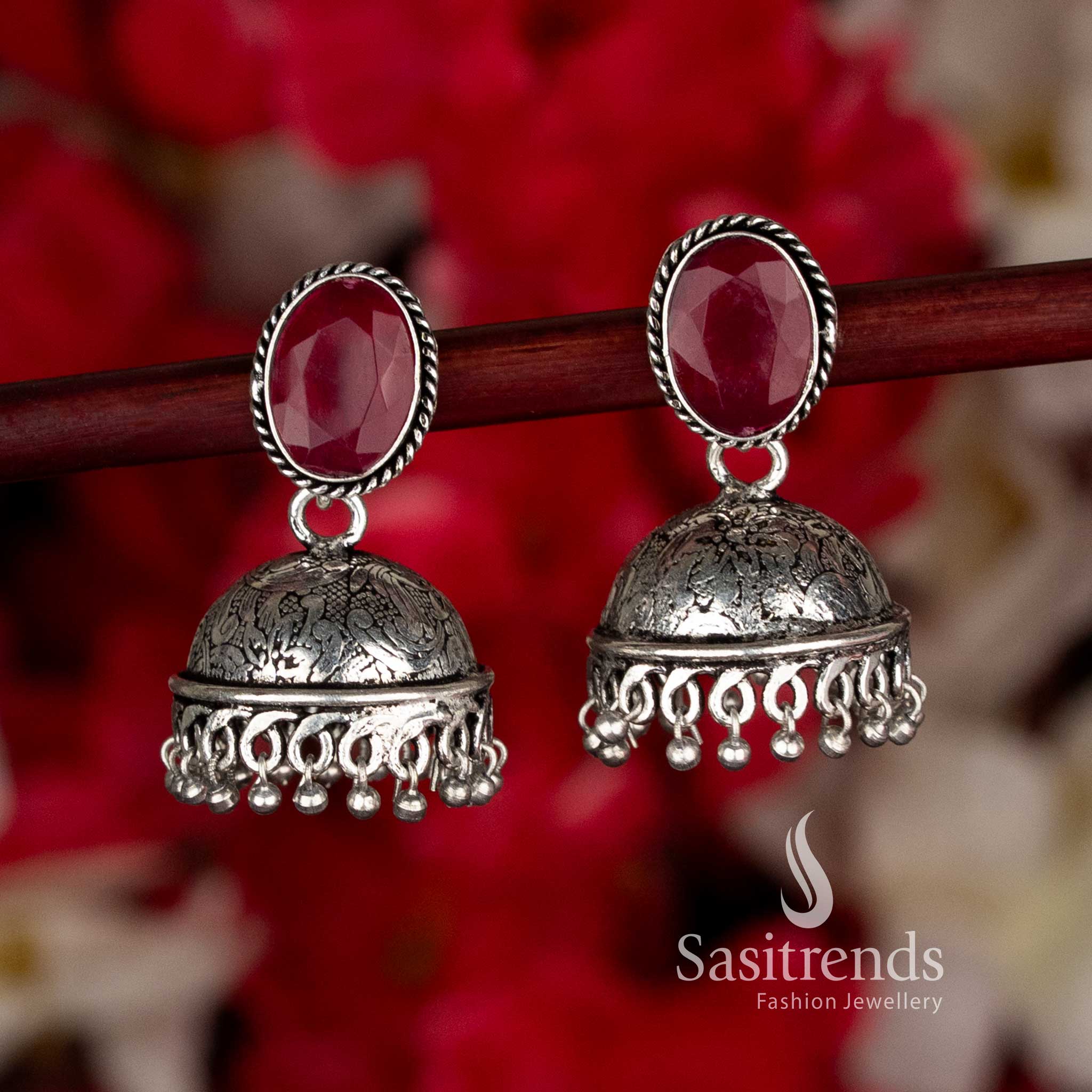 Sparkling ruby oxidised oval stone jhumka earrings enhanced with bead accents for an alluring black saree party look by Sasitrends