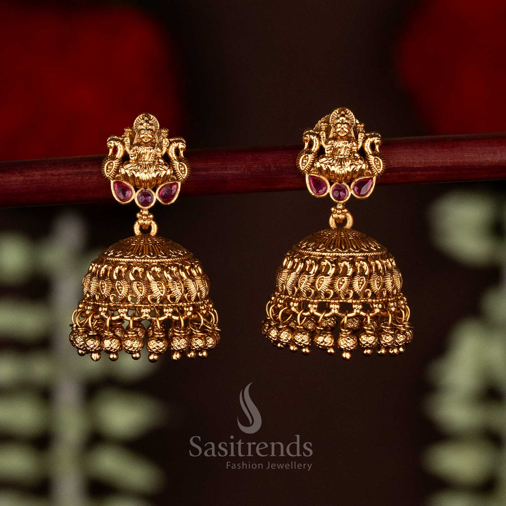 Radiant ruby temple matte gold plated Goddess Lakshmi jhumka earrings featuring delicate cluster beads, ideal for traditional wedding ceremonies and ethnic bridal wear by Sasitrends