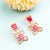 Radiant Rose Gold Plated Ruby Earrings with American Diamond Stones
