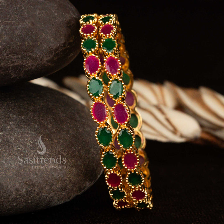 Micro gold plated American diamond bangles featuring ruby-green oval shaped stones and intricate elegant craftsmanship – a regal traditional jewellery pair perfect for festive and bridal wear by Sasitrends