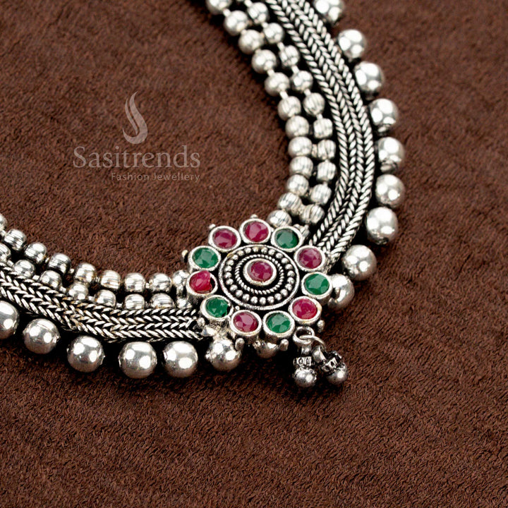 Handcrafted oxidised silver ruby-green choker necklace set with stone embellishments and a detailed floral pendant, radiating regal ethnic splendour – ornate festive jewellery design by Sasitrends.