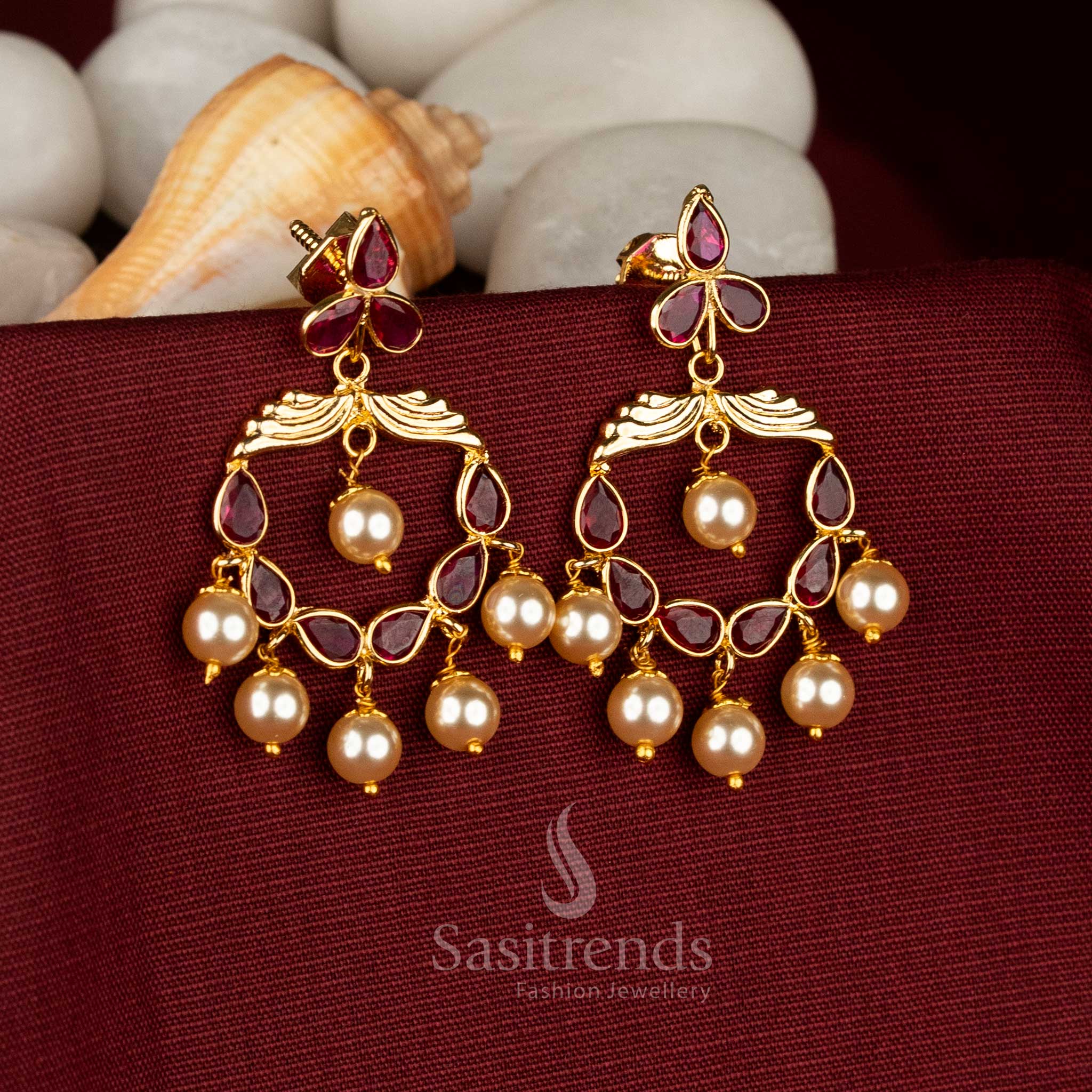Ruby tone crescent earrings graced with vibrant Kundan brilliance, AD sparkle and delicate pearls crafted for statement charm during grand celebrations – Sasitrends