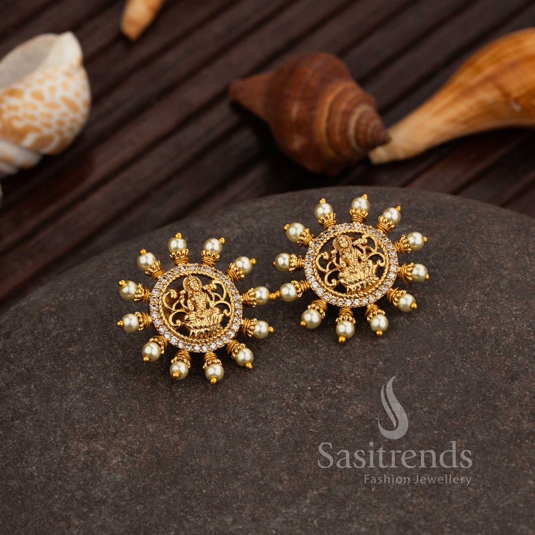 Divine Matte Gold Plated Lakshmi Temple Stud Earrings With White Pearl Hangings And Glittering AD Stone Detailing, A Serene Traditional Bridal Jewellery Creation With Temple-Inspired Craftsmanship – Sasitrends