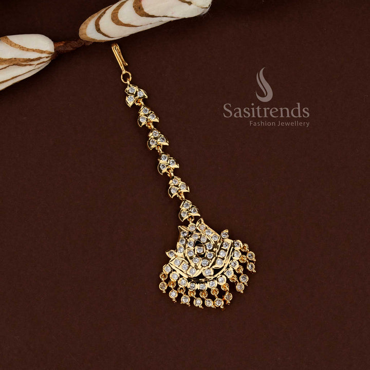 Sacred white lotus inspired Impon micro gold plated AD maang tikka created for bridal beauty wedding ceremonies festive styling and elegant ethnic jewellery look - Sasitrends