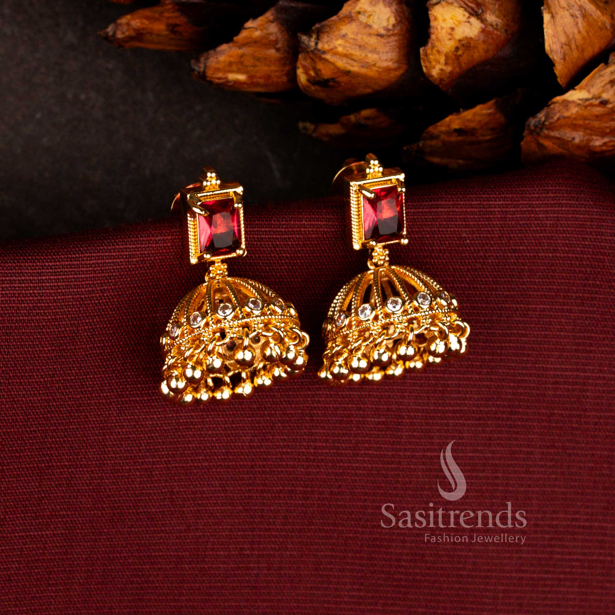 Elegant Sasitrend ruby 24K micro gold plated festive jhumka earrings crafted with layered bead hangings and rich traditional finish