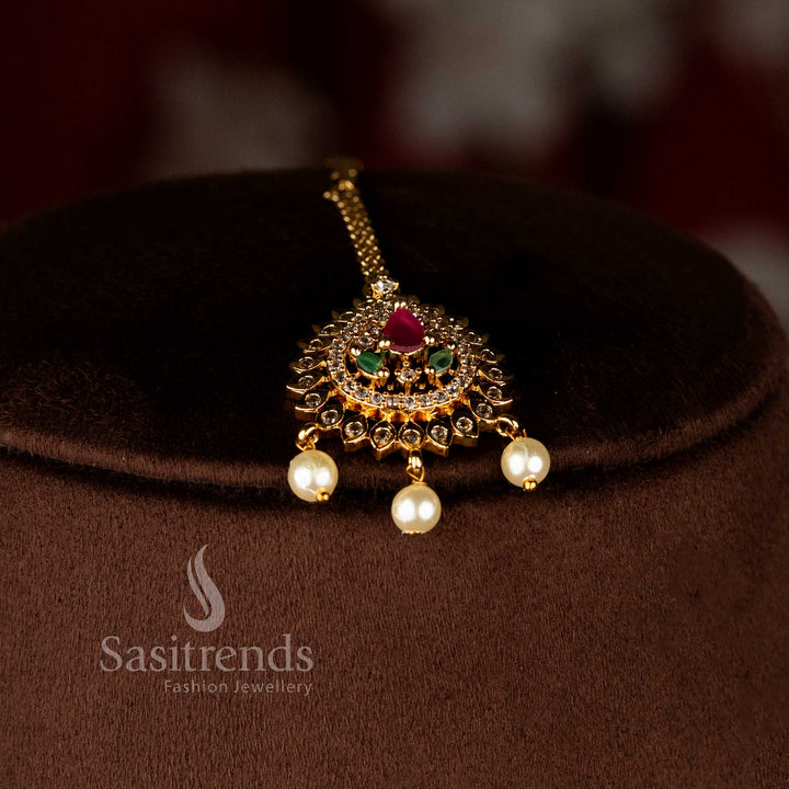 Celestria beam grand matte gold plated maang tikka featuring shimmering American diamond detailing and vibrant multi teardrop design for bridal aura – Sasitrends