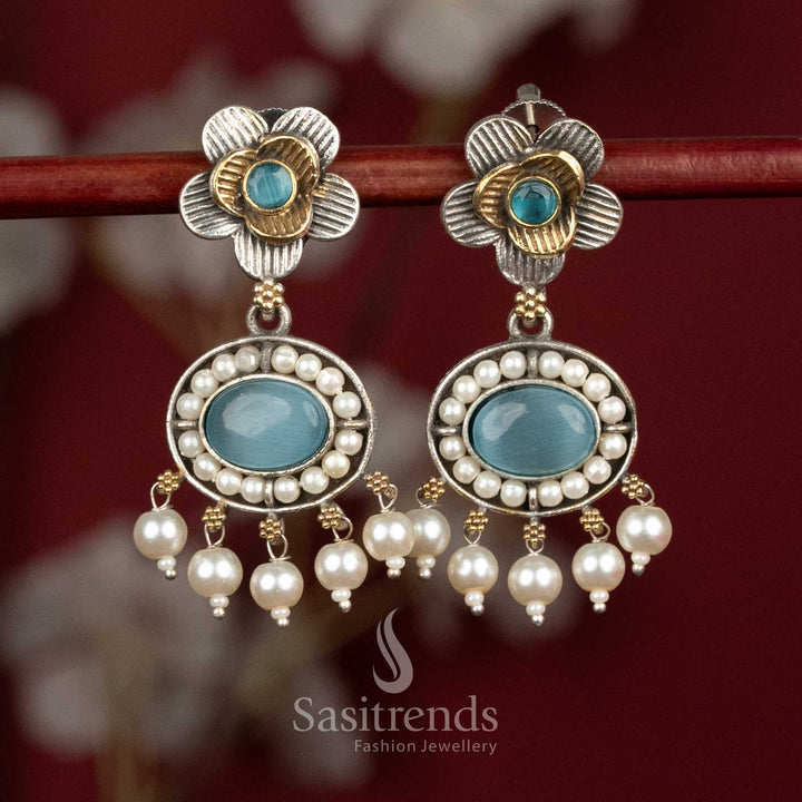Radiant oxidised silver floral stud earrings adorned with sky-blue Monalisa stones, sculpted floral patterns and clustered pearl drops for sophisticated festive wear - Sasitrends