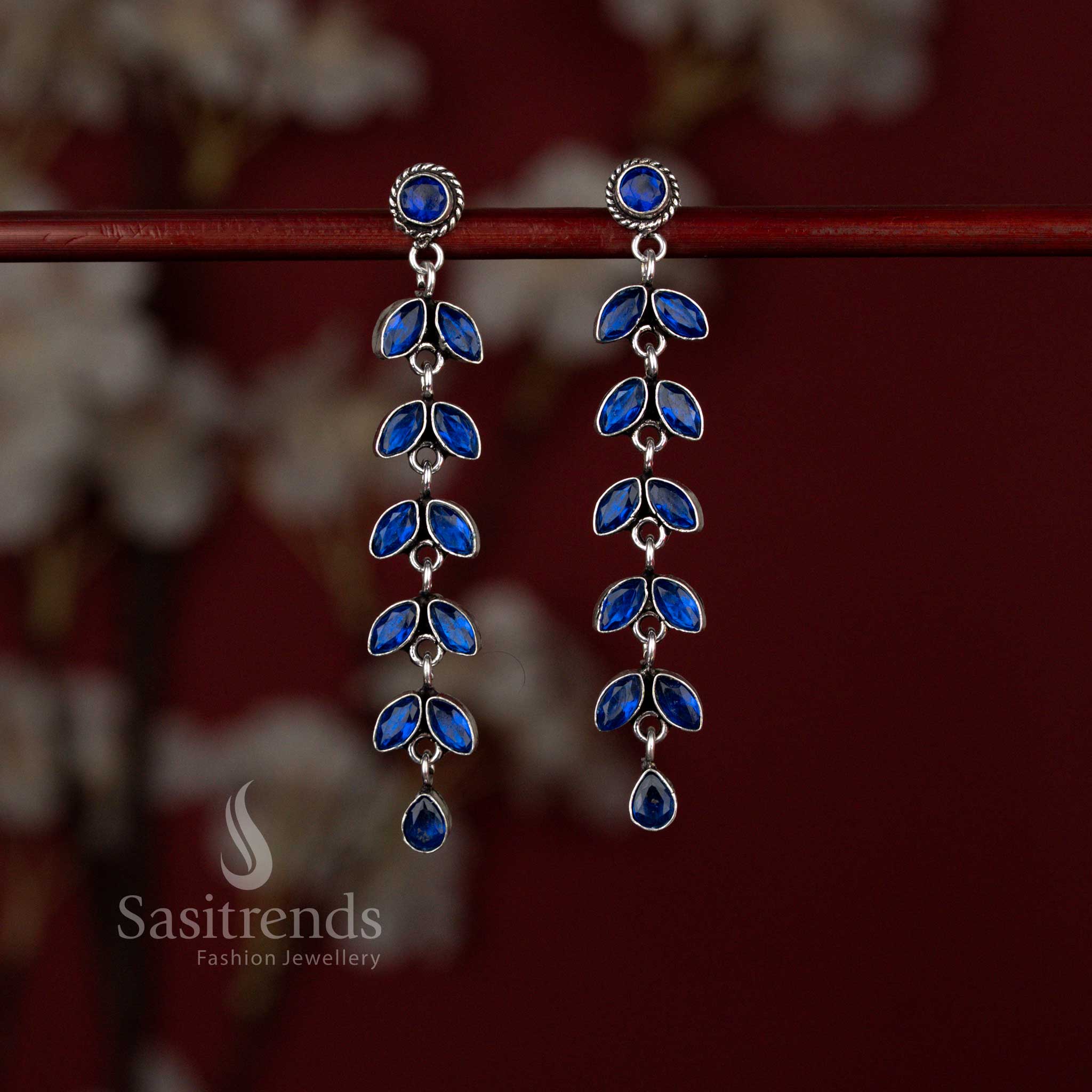 Refined oxidised linear leaf drop earrings highlighted with blue charm ideal for ethnic outfits and celebration styling – Sasitrends
