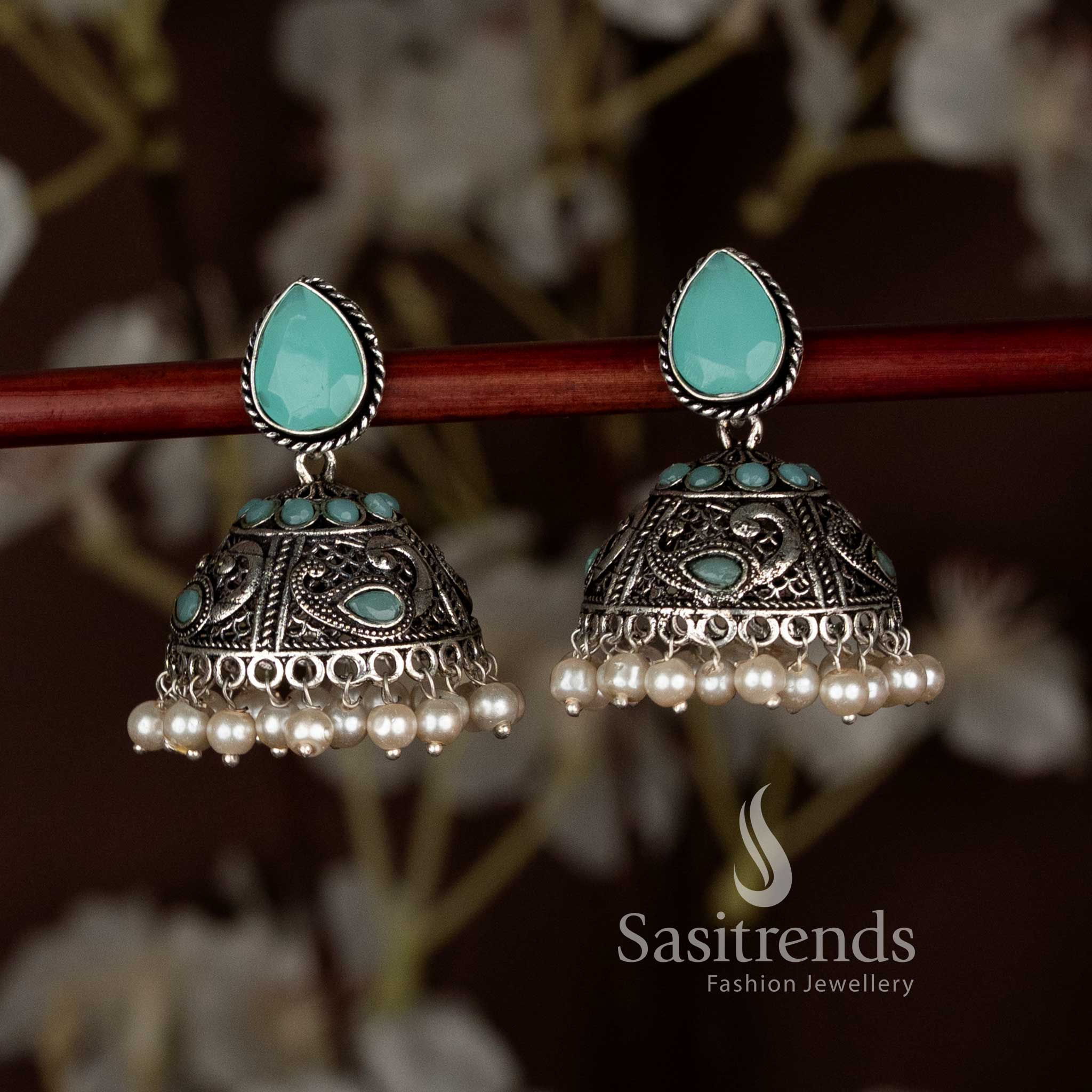 Charming sky-blue oxidised peacock motif teardrop stud jhumka earrings with pearl drops, designed for Navaratri party looks and elegant ethnic saree styling by Sasitrends