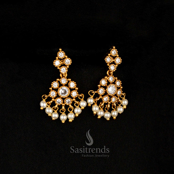 Ivory luxe matte gold AD floral drop earrings featuring white circular motifs, ideal for traditional elegance at weddings and festive occasions – Sasitrends