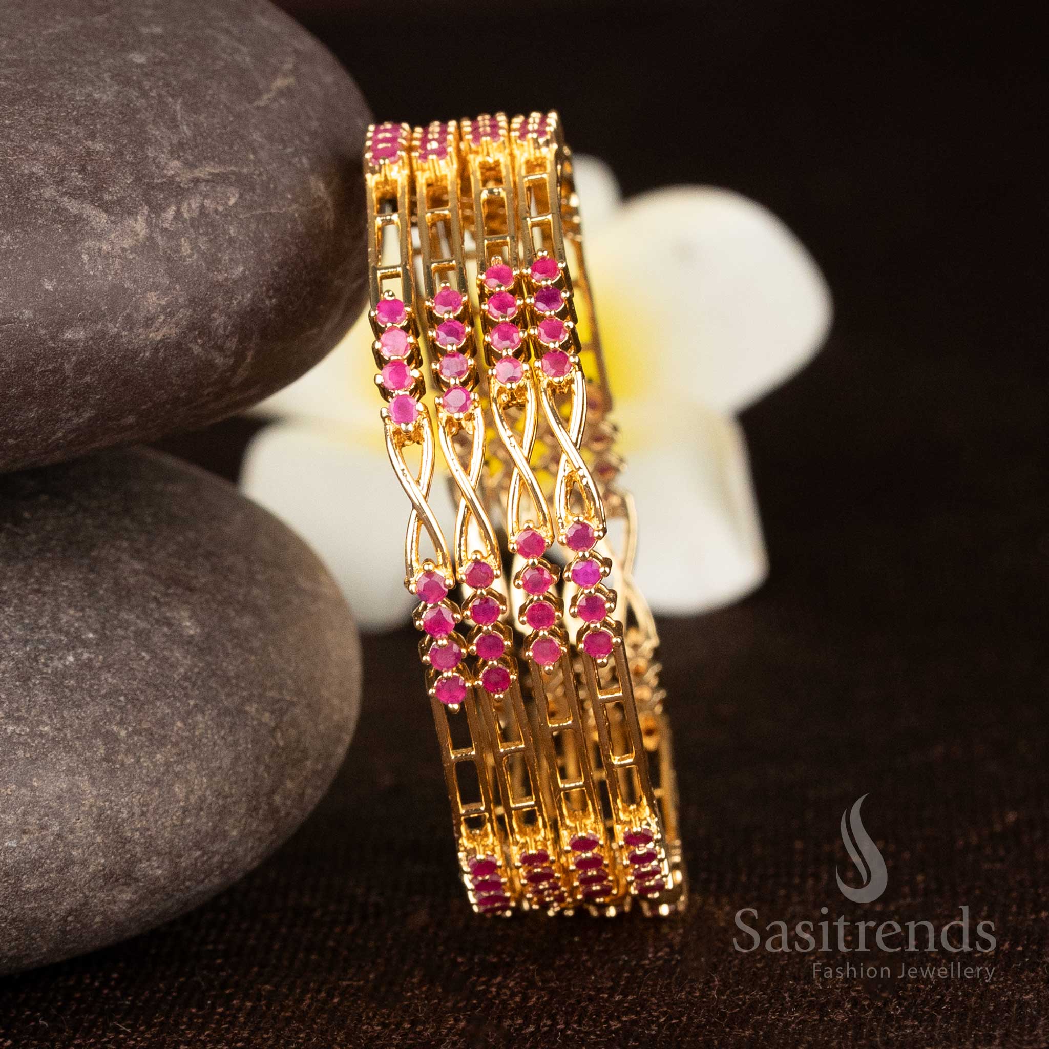 Lustrous ruby one gram gold plated bangles in twisted design highlighted with sparkling American diamonds - Sasitrends