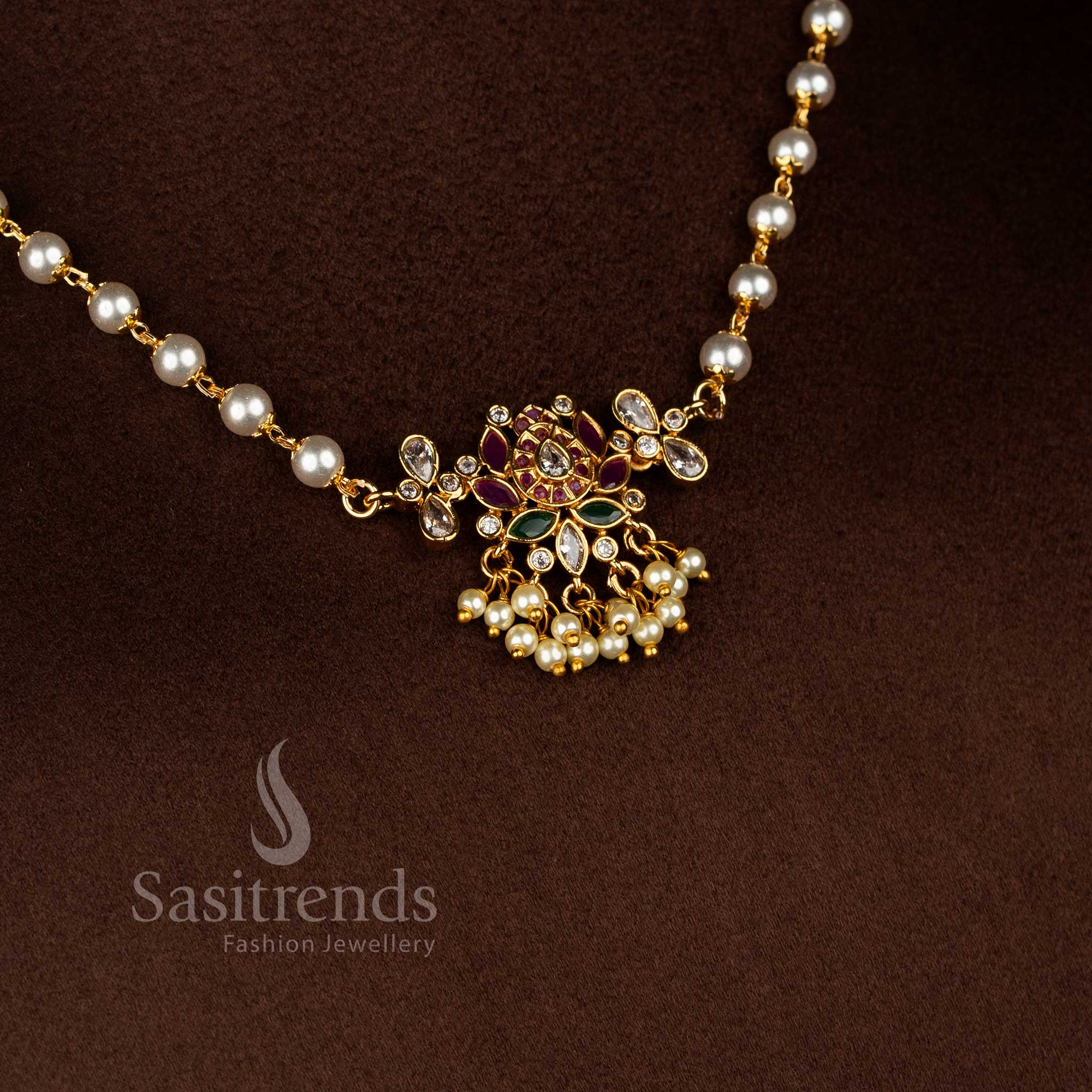 Regal traditional temple matte gold tone lotus teardrop pearl choker set highlighted with radiant American diamond stones and coordinated earrings reflecting ethnic splendour jewellery - Sasitrends